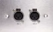 Dual 3 pin XLR microphone connectors mounted horizontally on a brushed stainless steel wall plate. “One-Shot” version with screw terminal connections for quick and easy connection on site. 